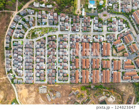 New development real estate. Aerial view of residential houses and driveways neighborhood during a fall sunset or sunrise time. Tightly packed homes. Top view over private houses in phuket thailand New development real estate. Aerial view of residential houses and driveways neighborhood during a fall sunset or sunrise time. Tightly packed homes. Top view over private houses in phuket thailand 124823847