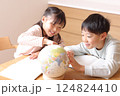 地球儀を見ながら勉強をする小学生男の子と女の子 124824410