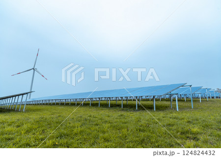 Wind turbine and solar panels on green fields in Germany Wind turbine and solar panels on green fields in Germany 124824432