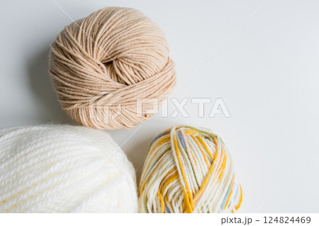 Assorted yarn balls in neutral and multicolor tones for knitting and crochet 124824469