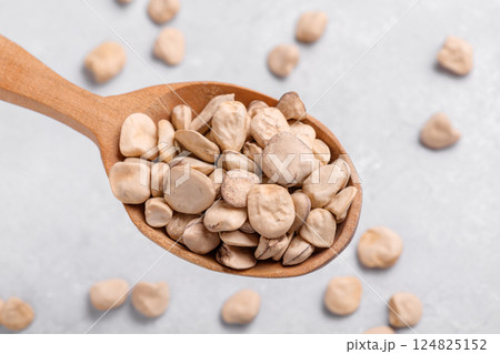 Raw dry Grass pea close up on wooden spoon 124825152