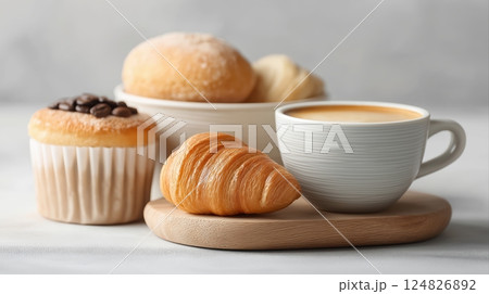 Freshly Baked Pastries and Coffee Cup on a Wooden Board for Morning Breakfast or Brunch Setting 124826892