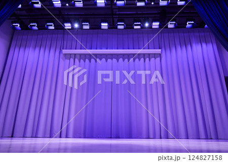 A stage with a platform in the form of a podium with a trendy purple color on the background. Fabric wavy background with space for copying. An element for your design. High quality photo 124827158