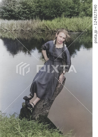 Vintage portrait of a beautiful girl on the river bank. Retro photo from 1957. Vintage portrait of a beautiful girl on the river bank. Retro photo from 1957. 124827840