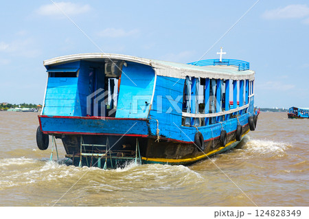 Wooden motor boat for transporting tourists between islands in the Mekong Delta in southern Vietnam 124828349