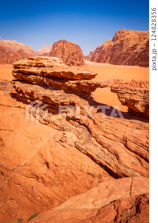 Wadi Rum, Jordan. Little Bridge arch and Khor Al Ajram, scenic valley with towering sandstone cliffs and breathtaking desert landscapes. 124828356