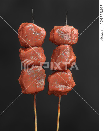 Delicious food featuring grilled meat kebab skewers perfect for barbecue cuisine. Delicious food featuring grilled meat kebab skewers perfect for barbecue cuisine. 124828867