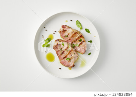 Food plate with meat and herbs, gourmet dinner with salt, pepper, grilled cuisine and olive oil 124828884