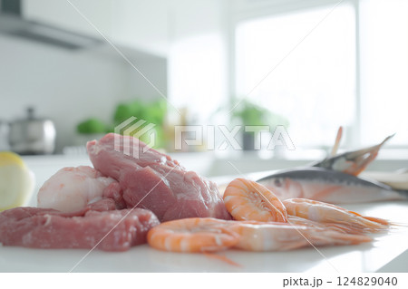 Fresh shrimp and meat in a kitchen setting with various ingredients for a delicious dish Fresh shrimp and meat in a kitchen setting with various ingredients for a delicious dish 124829040