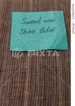 Motivational note placed on fabric reminds to work hard for future success 124829545