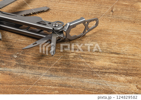 Lviv Ukraine 04.02.25 Multi-tool showcasing various useful features on wood Lviv Ukraine 04.02.25 Multi-tool showcasing various useful features on wood 124829582