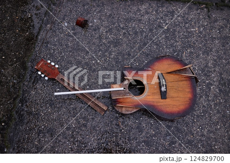 Broken guitar in snowy rain 124829700