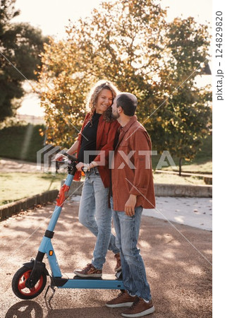 Couple Enjoying a Romantic Moment on Electric Scooter 124829820