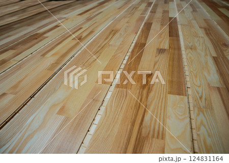 Production line of the wooden floor factory. CNC automatic woodworking machine. Production line of the wooden floor factory. CNC automatic woodworking machine. 124831164