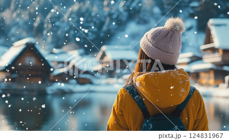 Adventurous Young Woman Delighting In Snowy Winter Wonderland Of Shirakawa-Go, Embracing The Beauty Of The Season With Joy And Wonder. 124831967