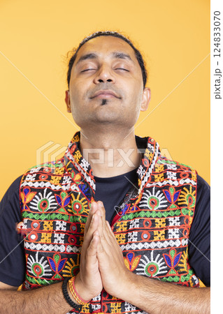 Indian man praying to his god, asking for forgiveness,practicing hinduism religion. Close up shot of spiritual person doing worship hand gesturing, confessing, begging for pardon, studio backdrop 124833070