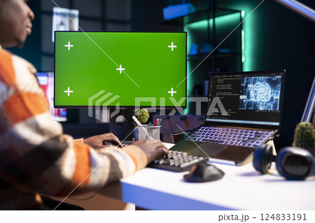African american man using AI to develop a software system with chroma key on pc, cloud computing. Male IT programmer showing his skill in coding and cyber security, machine learning. 124833191