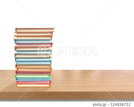 Stack of books on a table with white background. Stack of colorful books on a wooden table. Stack of books on a table with white background. Stack of colorful books on a wooden table. 124836712