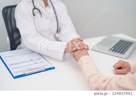 doctor holding hands with elderly female patient, showing empathy and support during a medical consultation. trust, Senior and geriatric care, healthcare, Mental Health, giving advice and emotional doctor holding hands with elderly female patient, showing empathy and support during a medical consultation. trust, Senior and geriatric care, healthcare, Mental Health, giving advice and emotional 124837601