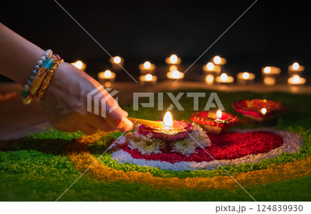 Clay diya lamps lit during diwali celebration, Diwali, or Dipawali, is India's biggest and most important holiday. 124839930