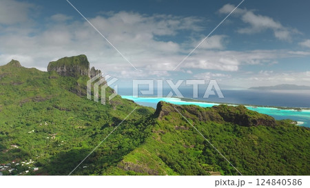 Impressive aerial view of bora bora island, french polynesia, revealing the iconic mount otemanu surrounded by turquoise waters and lush vegetation Impressive aerial view of bora bora island, french polynesia, revealing the iconic mount otemanu surrounded by turquoise waters and lush vegetation 124840586