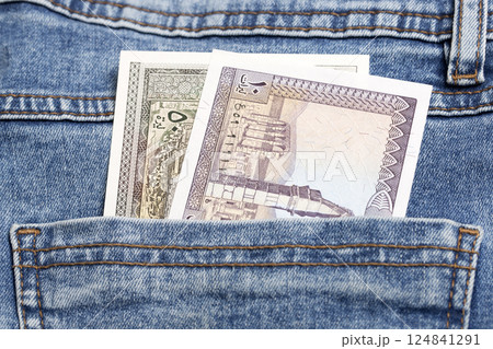 Old Lebanese pound in the pocket of blue jeans Old Lebanese pound in the pocket of blue jeans 124841291