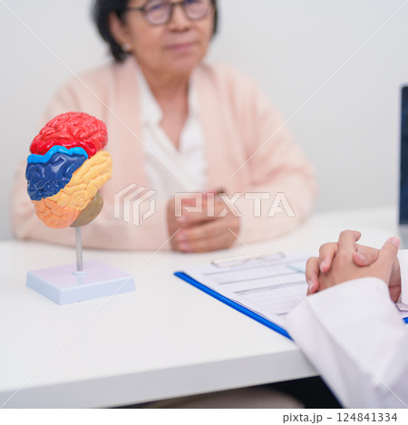 Elderly Patient consulting Doctor to Brain disease, Senior Health Medical Diagnosis. Anatomy Brain model for Explanation, Brain Tumor, neurological disorders, Dementia, alzheimer, parkinson and Mental 124841334