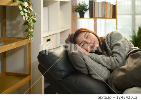Young asian woman is sleeping on comfortable armchair with a pillow 124842012