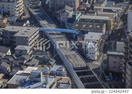 Red Train Passing by Canal in Urban City Neighborhood Dec 8 2024 124842447