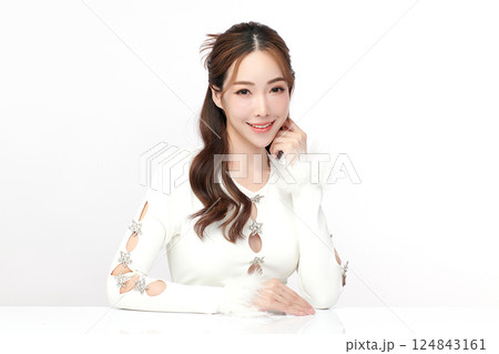 A beautiful young Asian woman with clean, fresh skin against a white background. Skincare, facial treatment, cosmetology, beauty, and spa. An elegant portrait of an Asian woman. A beautiful young Asian woman with clean, fresh skin against a white background. Skincare, facial treatment, cosmetology, beauty, and spa. An elegant portrait of an Asian woman. 124843161