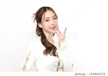 A beautiful young Asian woman with clean, fresh skin against a white background. Skincare, facial treatment, cosmetology, beauty, and spa. An elegant portrait of an Asian woman. 124843172