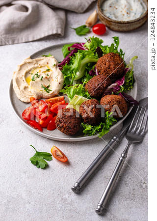 Salad with hummus, falafel and vegetables 124843234
