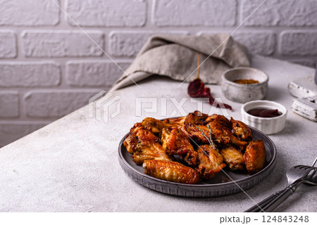 Baked spicy chicken wings with sauce Baked spicy chicken wings with sauce 124843248