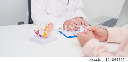 Elderly Patient consulting Doctor to Ear disease. Senior Health Medical Diagnosis. Anatomy Ear model for Atresia, Otitis Media, Pertorated Eardrum, Meniere syndrome, otolaryngologist, Hearing Loss 124844535