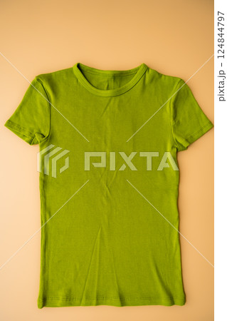 Moss green ribbed t-shirt on beige background, sustainable fashion and second-hand clothing Moss green ribbed t-shirt on beige background, sustainable fashion and second-hand clothing 124844797