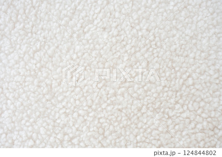 A highly detailed close-up of fluffy white sherpa fleece with a textured surface 124844802