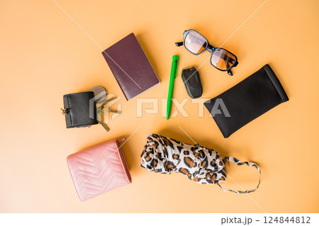 Flat lay of everyday essentials on a pastel background. 124844812