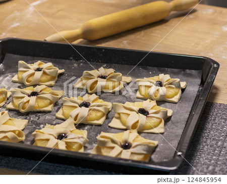 Just baked fruit puff pastry on the baking tray, dusted with powdered sugar Just baked fruit puff pastry on the baking tray, dusted with powdered sugar 124845954