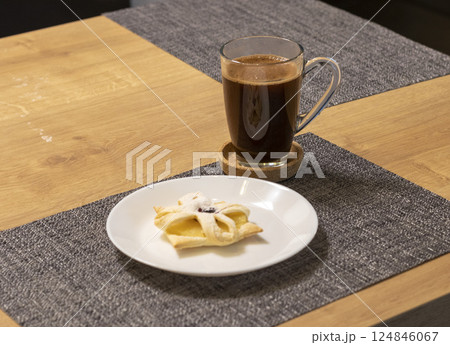Freshly baked fruit puff pastry on the ceramic plate next to hot cup of coffee Freshly baked fruit puff pastry on the ceramic plate next to hot cup of coffee 124846067