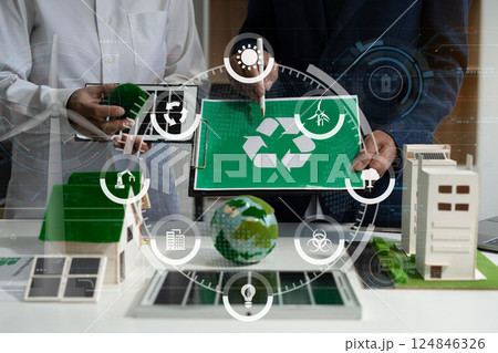 Two colleagues discussing data sustainable development with renewable energy solutions, ecology concept, green business. 124846326