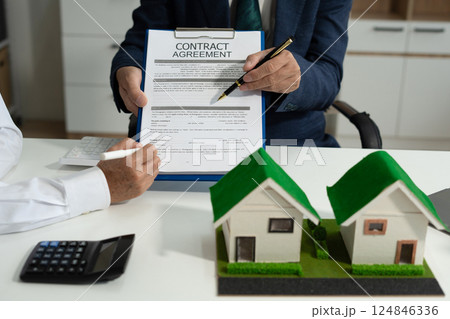 House model with agent asking costumer for contract to buy, get insurance or loan real estate or property. 124846336
