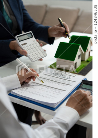 House model with agent asking costumer for contract to buy, get insurance or loan real estate or property. House model with agent asking costumer for contract to buy, get insurance or loan real estate or property. 124846338