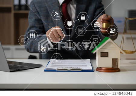 Justice and law concept. Real Estate Law in a courtroom the gavel, working with digital tablet computer on wood table in sun light. 124846342