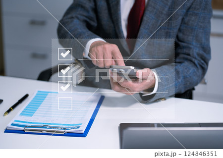 Businessman recording phone inquiry with checkboxes survey, doing assessment online survey answer test questions Digital form. 124846351