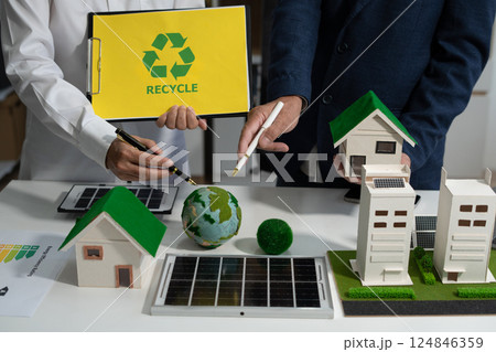 Two colleagues discussing data sustainable development with renewable energy solutions, ecology concept, green business. 124846359