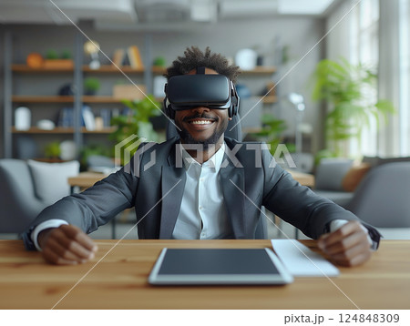 Business portrait rich corporate African American man business suit outstretched arms sitting desk office wearing VR headset glasses. Reality using technology work. Concept using modern technology Business portrait rich corporate African American man business suit outstretched arms sitting desk office wearing VR headset glasses. Reality using technology work. Concept using modern technology 124848309