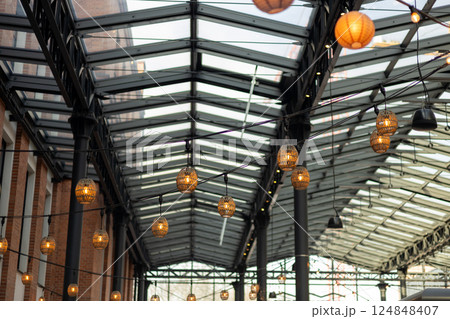 Garlands of lamps on the street. Light bulb decor, the string of lights on a urban background 124848407