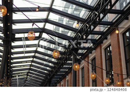 Garlands of lamps on the street. Light bulb decor, the string of lights on a urban background 124848408