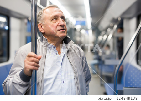 Portrait of senior positive man 60 year old in subway car 124849138