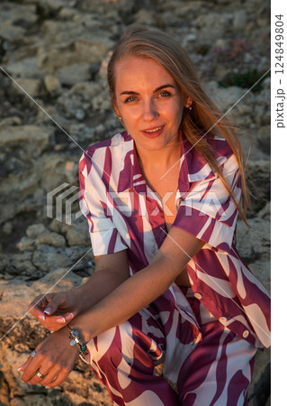Beautiful slender blonde woman in silk suit 124849804